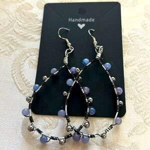 Wire wrapped teardrop shaped earrings. Blue, Blackand silver.